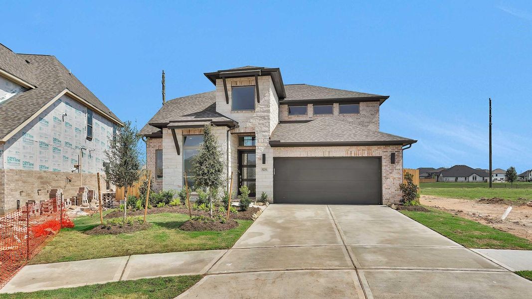 Front exterior of a new home in Stonecreek Estates 50', Richmond, TX, highlighting curb appeal (Image 2). Front exterior of a new home in Stonecreek Estates 50', Richmond, TX, highlighting curb appeal (Image 2).