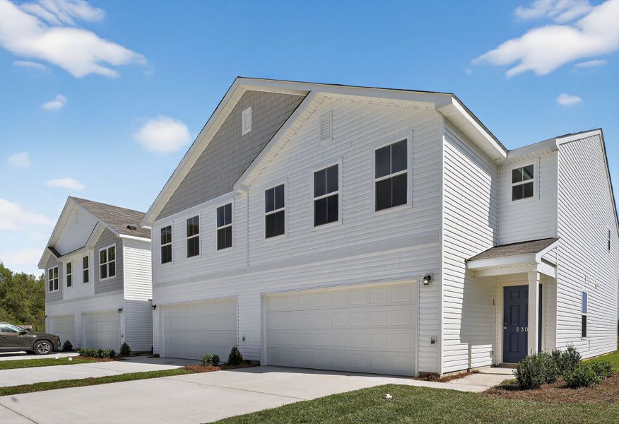 A white house with a garage. A white house with a garage.