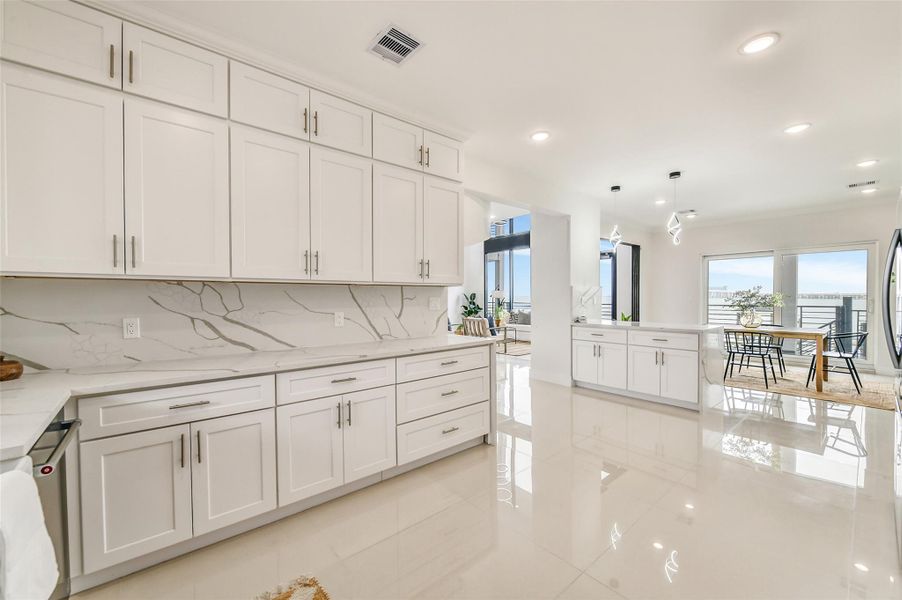 The kitchen blends beauty and performance seamlessly. Quartz countertops, generous workspace, and refined finishes make every meal feel elevated.