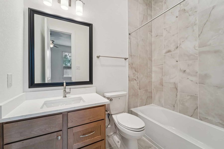 Representative furnished interior of a home built from the Lauren by Chesmar Homes in University Heights, Round Rock (Image 11).