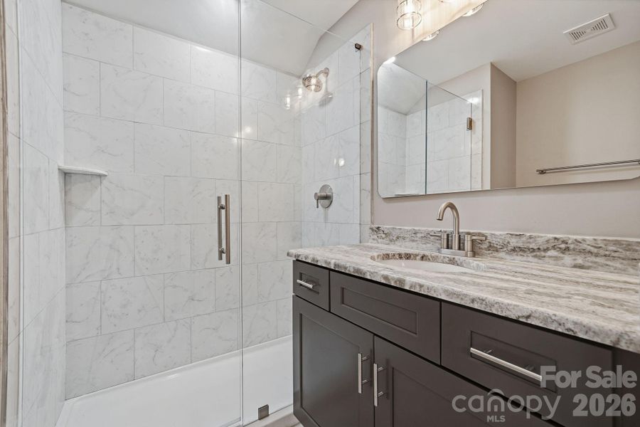 Detail of beautifully tiled guest shower — designer finish throughout Detail of beautifully tiled guest shower — designer finish throughout