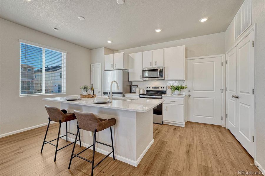 Kitchen offers LVP flooring, natural light...