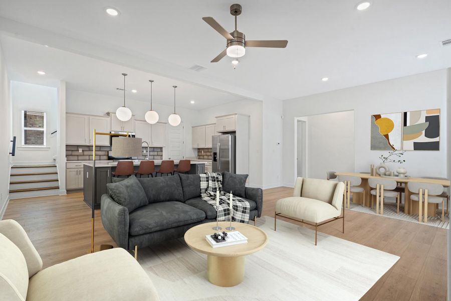 Open-concept living space featuring wood-finish flooring, recessed lighting, and a ceiling fan Open-concept living space featuring wood-finish flooring, recessed lighting, and a ceiling fan