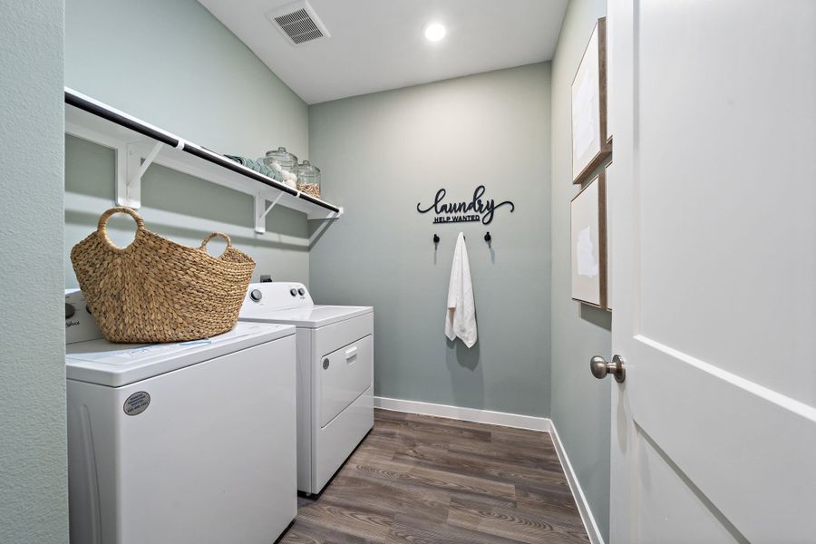 A laundry room with a basket on the wall. A laundry room with a basket on the wall.