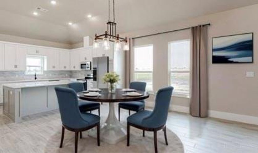 Dining area featuring an inviting chandelier, light wood-type flooring, and lofted ceiling