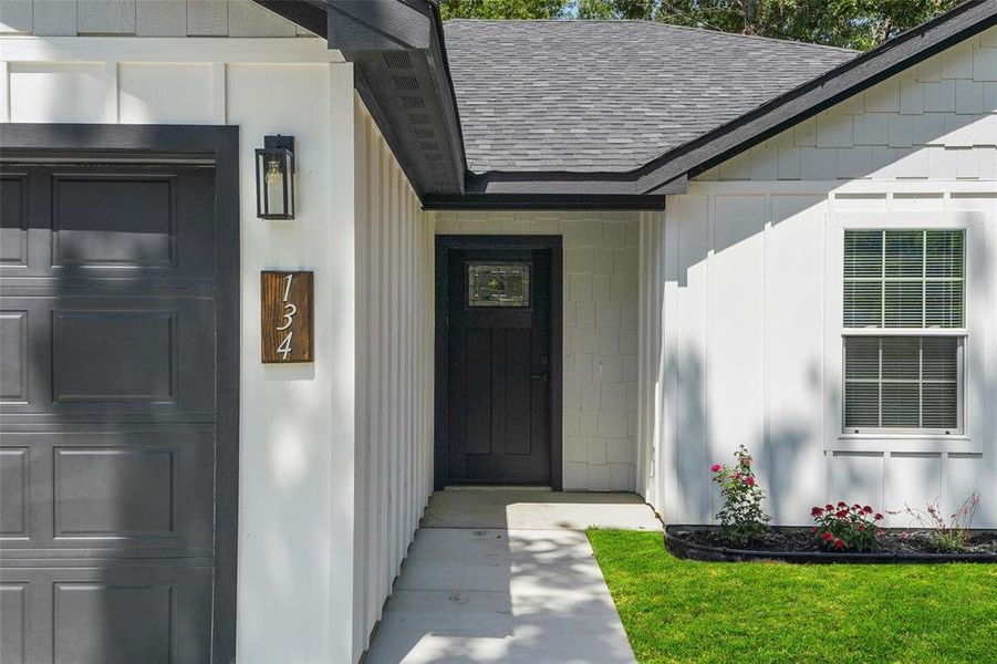 Crisp white board and batten siding with black trim accents Crisp white board and batten siding with black trim accents