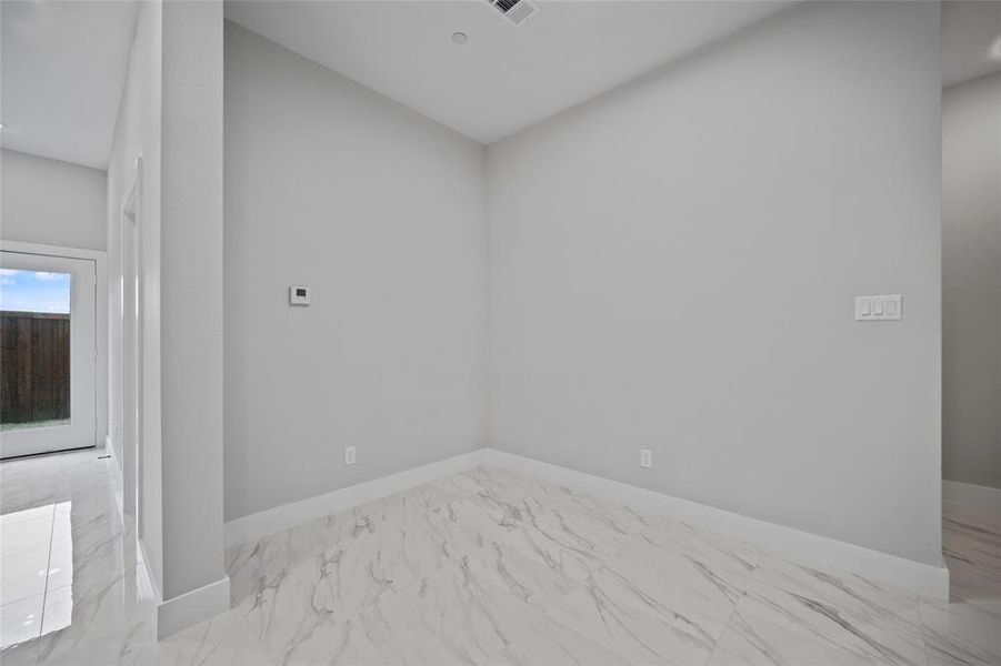 Unfurnished room with visible vents, marble finish floor, and baseboards