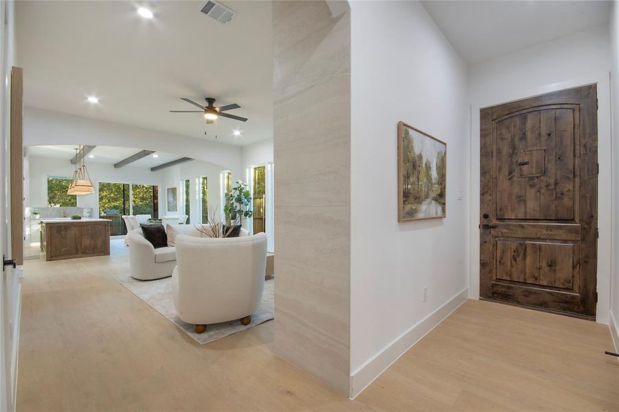 Entrance foyer featuring light wood-style floors, beam ceiling, arched walkways, recessed lighting, and ceiling fan