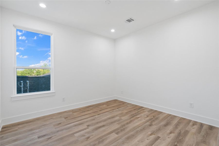 Durable LVP flooring flows seamlessly throughout the home, including all bedrooms, creating a cohesive and modern look. It’s easy to maintain while providing warmth and elegance underfoot. This choice enhances the home’s open, airy feel and complements its light, airy design.