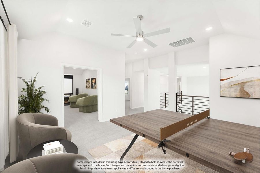 Upstairs game room with ping pong table, ceiling fan, and open view to media room beyond stair railing Upstairs game room with ping pong table, ceiling fan, and open view to media room beyond stair railing