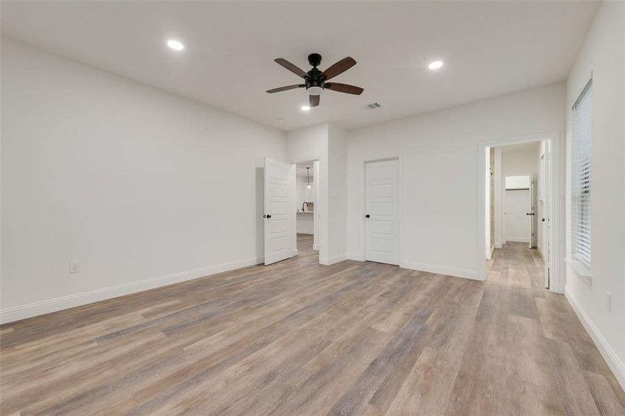 Unfurnished bedroom with a closet, light wood-type flooring, and ceiling fan