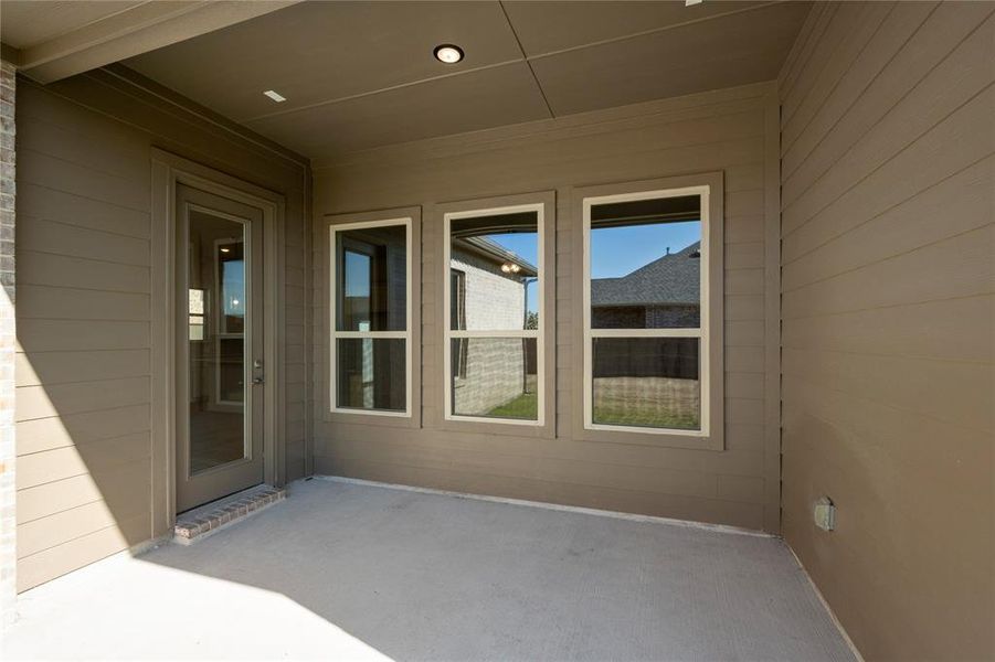 Picture yourself sitting on this covered back patio sipping morning coffee.