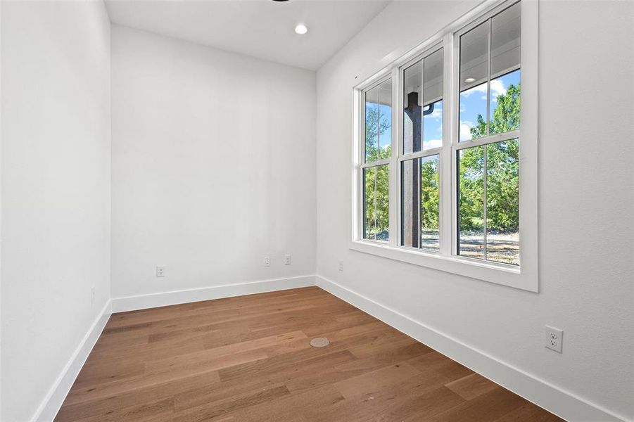 Unfurnished room featuring wood finished floors and recessed lighting Unfurnished room featuring wood finished floors and recessed lighting