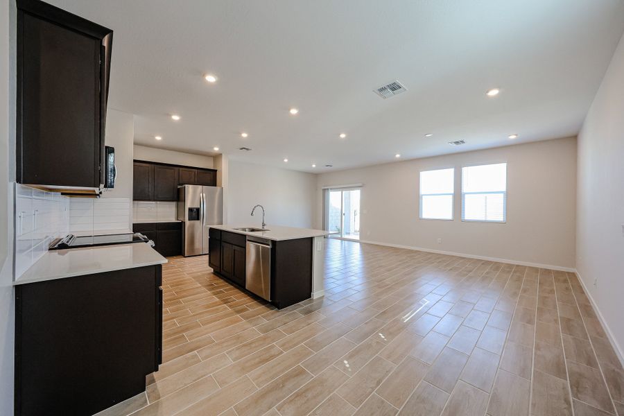 A large kitchen with a wood floor. A large kitchen with a wood floor.