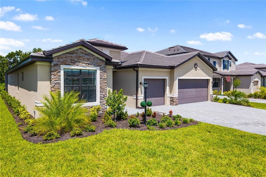 Front exterior of a new home in , Bradenton, FL, highlighting curb appeal (Image 1).
