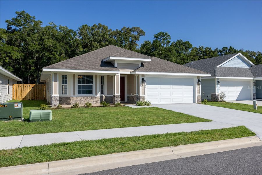 Front exterior of a new home in Savannah Station, Alachua, FL, highlighting curb appeal (Image 2).