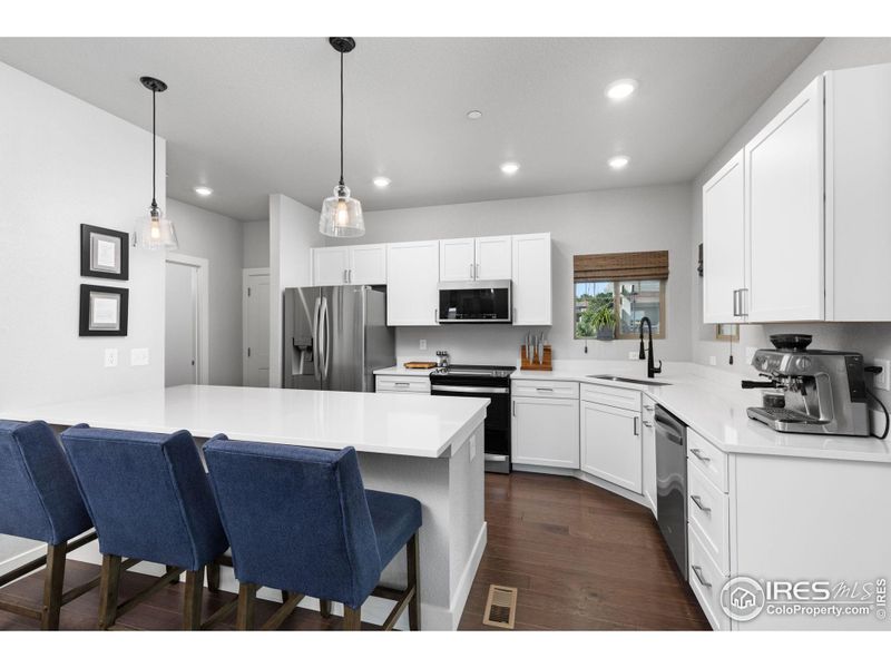 Kitchen has quartz countertops.