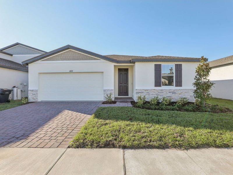 Front exterior of a new home in Lake Deer Estates - Signature Series, Poinciana, FL, highlighting curb appeal (Image 1).