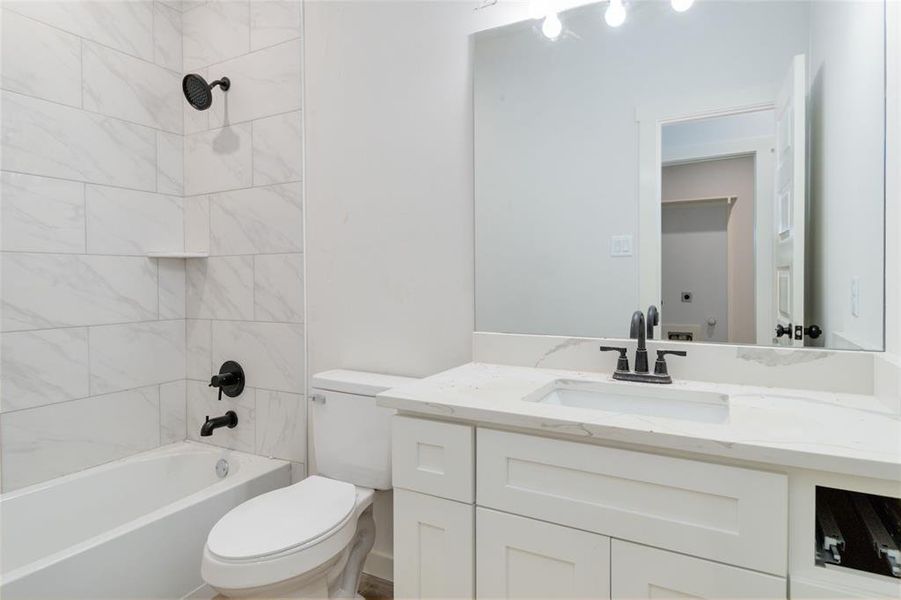 Second full bathroom with tile and shower/tub combo