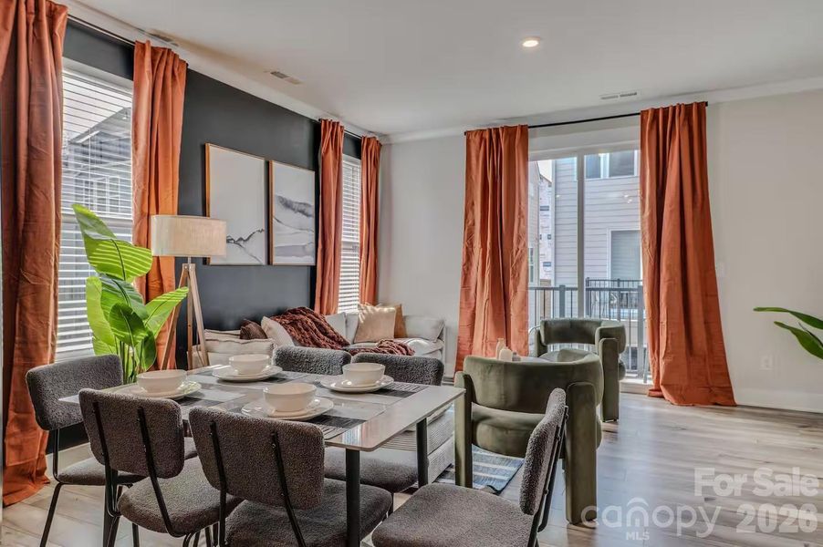 The bright, open-concept living and dining area is filled with natural light and offers the perfect space for everyday living, entertaining, and seamless access to the private balcony. The bright, open-concept living and dining area is filled with natural light and offers the perfect space for everyday living, entertaining, and seamless access to the private balcony.
