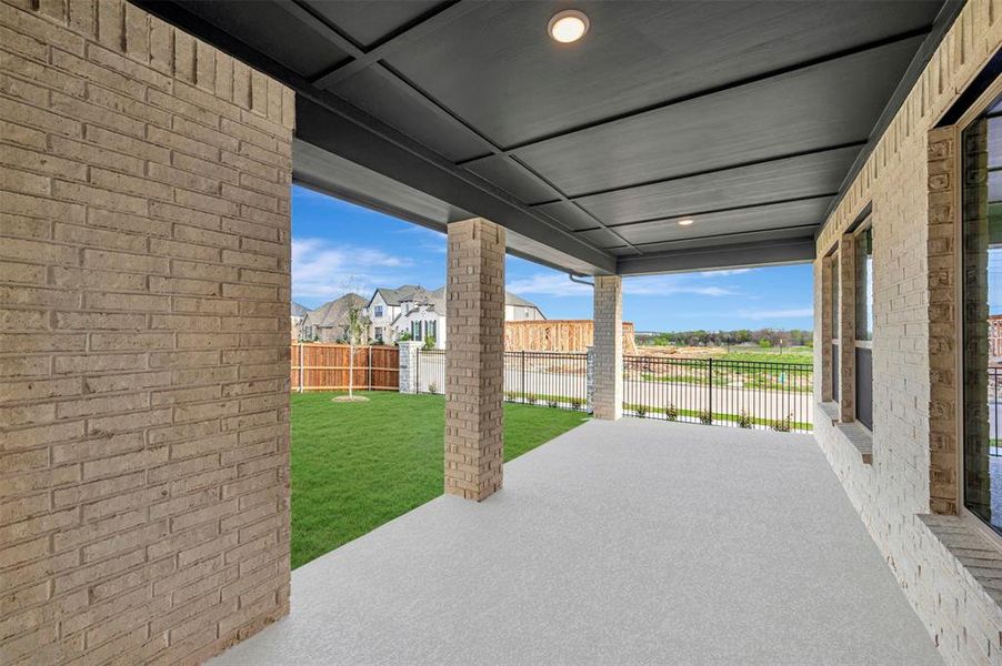 Fenced backyard featuring a patio and a residential view