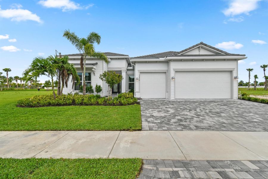 Front exterior of a new home in Avondale at Avenir, Palm Beach Gardens, FL, highlighting curb appeal (Image 14).