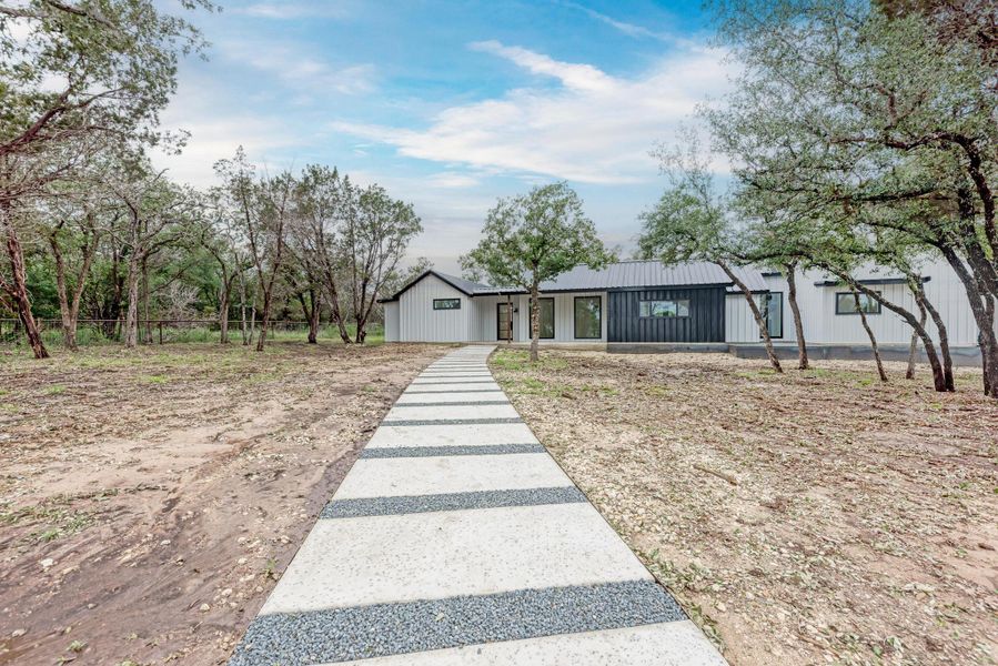 Front exterior of a new home in , Bertram, TX, highlighting curb appeal (Image 1).