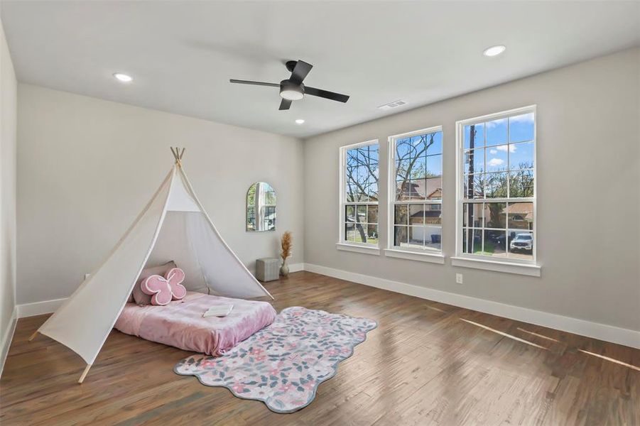 Bedroom featuring wood finished floors, ceiling fan, and recessed lighting Bedroom featuring wood finished floors, ceiling fan, and recessed lighting