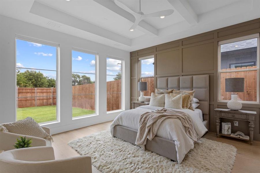Bedroom with a decorative wall, wood finished floors, beam ceiling, and coffered ceiling Bedroom with a decorative wall, wood finished floors, beam ceiling, and coffered ceiling