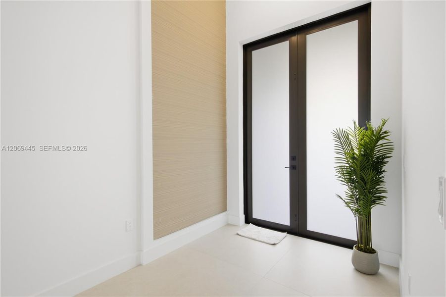 Impressive double-door entry with soaring ceilings creates a bright, modern first impression. Impressive double-door entry with soaring ceilings creates a bright, modern first impression.