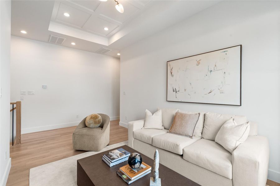 Soft cove lighting washes up into the tray ceiling, creating that elevated, hotel-lounge glow the rest of the home echoes. It's a small architectural touch that changes how the whole room feels at night.
