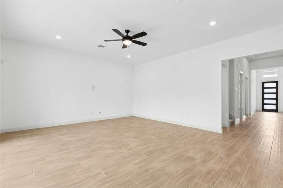 Unfurnished room featuring wood tiled floors, recessed lighting, and ceiling fan Unfurnished room featuring wood tiled floors, recessed lighting, and ceiling fan