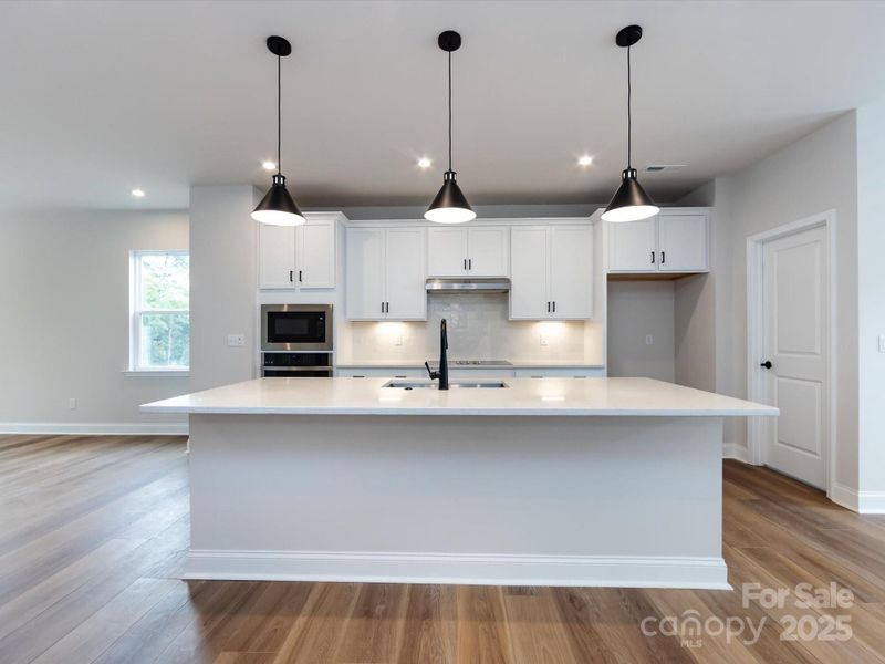 Crisp White Cabinetry and Matte Black Pendant Lighting