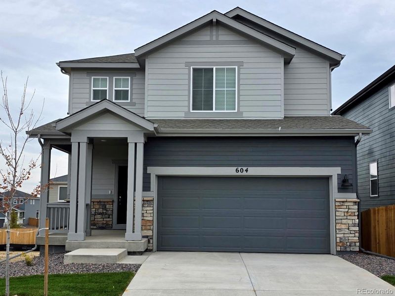 Front exterior of a new home in Lake Bluff, Greeley, CO, highlighting curb appeal (Image 1). Front exterior of a new home in Lake Bluff, Greeley, CO, highlighting curb appeal (Image 1).