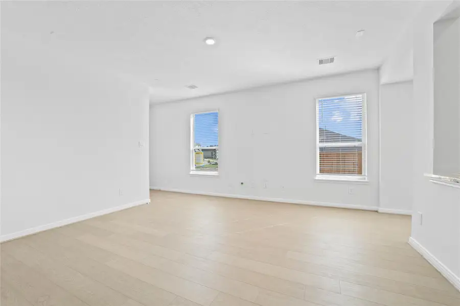 Imagine relaxing evenings and lively get togethers in the Great Room, the true centerpiece of the home. The Toasted Sienna vinyl plank flooring provides a warm foundation, while large windows and high ceilings bathe the space in natural light. Recessed lighting adds a sophisticated touch, and the fluid access to the kitchen ensures you're always part of the action. Imagine relaxing evenings and lively get togethers in the Great Room, the true centerpiece of the home. The Toasted Sienna vinyl plank flooring provides a warm foundation, while large windows and high ceilings bathe the space in natural light. Recessed lighting adds a sophisticated touch, and the fluid access to the kitchen ensures you're always part of the action.