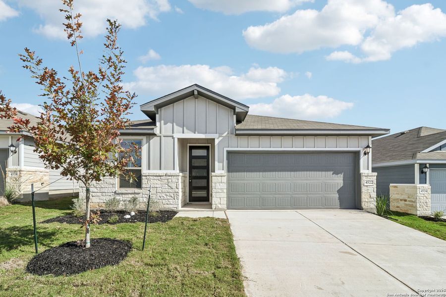 Front exterior of a new home in Remington Ranch, San Antonio, TX, highlighting curb appeal (Image 19). Front exterior of a new home in Remington Ranch, San Antonio, TX, highlighting curb appeal (Image 19).