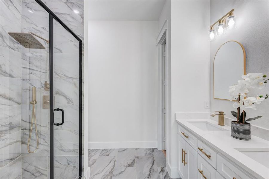 Bathroom featuring vanity and a shower with door