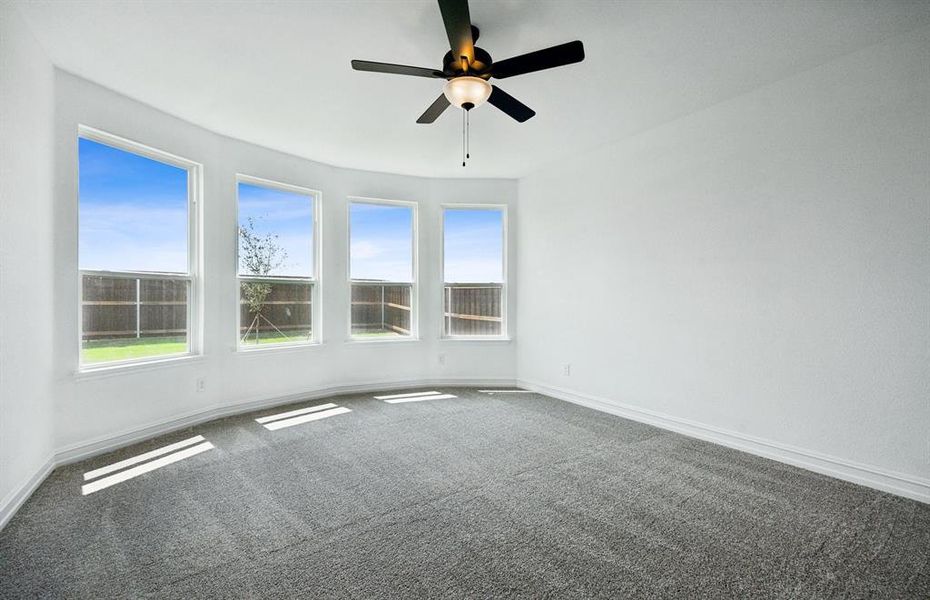 Elegant owner's suite with bay window *real home pictured