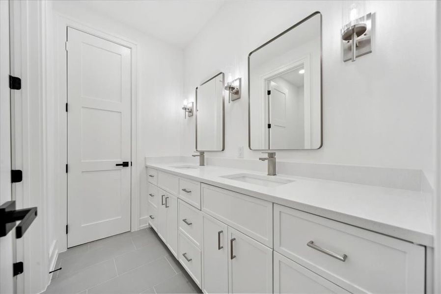 Bathroom with tile patterned flooring and double sink vanity