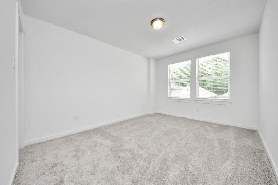 Generously sized secondary bedrooms featuring spacious closets, soft and inviting carpeting underfoot, large windows allowing plenty of natural light, and the added touch of privacy blinds for your personal retreat. Sample photo of completed home with similar floor plan. Actual colors and selections may vary. Generously sized secondary bedrooms featuring spacious closets, soft and inviting carpeting underfoot, large windows allowing plenty of natural light, and the added touch of privacy blinds for your personal retreat. Sample photo of completed home with similar floor plan. Actual colors and selections may vary.