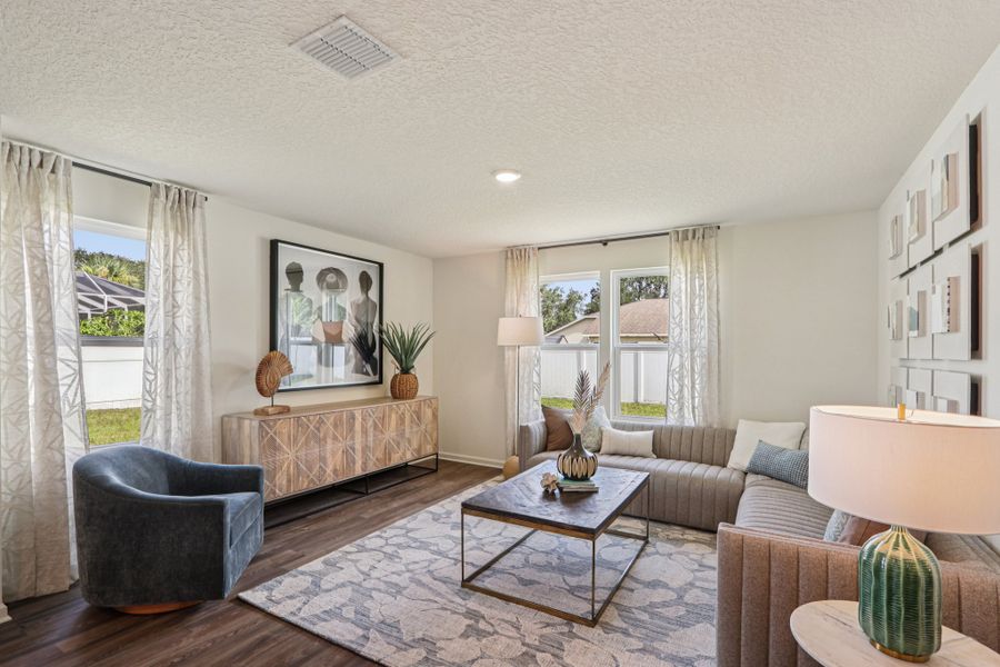 A living room with a couch and a table. A living room with a couch and a table.