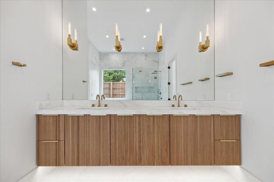 Bathroom featuring tile flooring, double sink vanity, and a tile shower