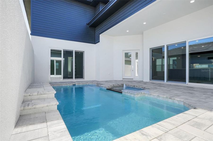 Exterior details and patio area of a home in Hampton Green at Providence, Davenport (Image 36).
