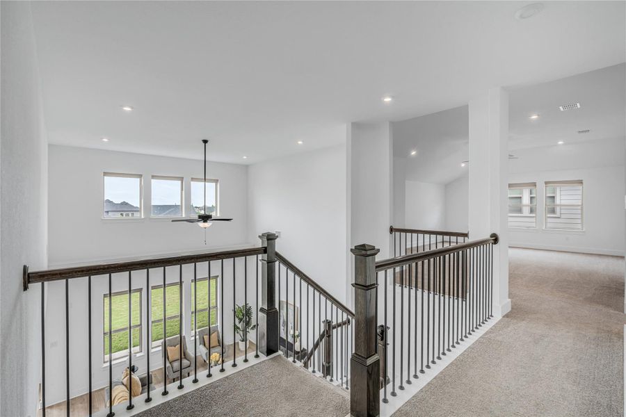 Overlooking the lower level, this versatile loft offers a comfortable area for gathering.