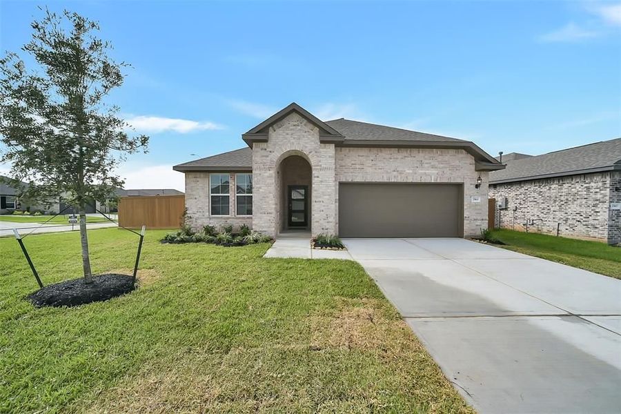 Front exterior of a new home in Sunterra, Katy, TX, highlighting curb appeal (Image 22).