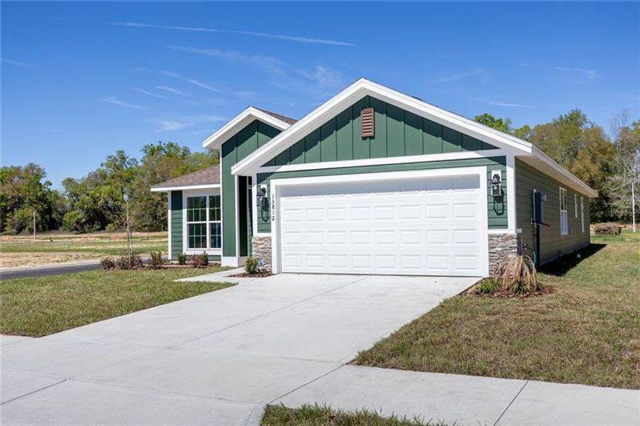 Front exterior of a new home in Briarwood, Alachua, FL, highlighting curb appeal (Image 13). Front exterior of a new home in Briarwood, Alachua, FL, highlighting curb appeal (Image 13).