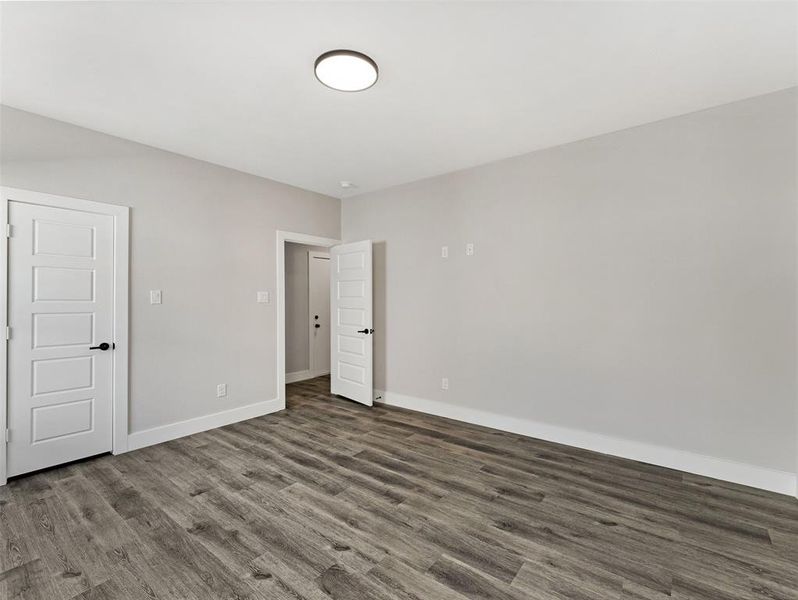 Unfurnished room with dark hardwood / wood-style flooring