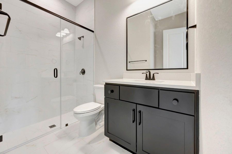 Ensuite bath/bedroom offers a walk-in shower w/tile to ceiling