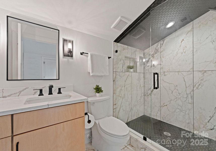 Full bathroom on the third level, complete with quartz countertops, tile floors, and floor to ceiling tile walk-in shower. Full bathroom on the third level, complete with quartz countertops, tile floors, and floor to ceiling tile walk-in shower.