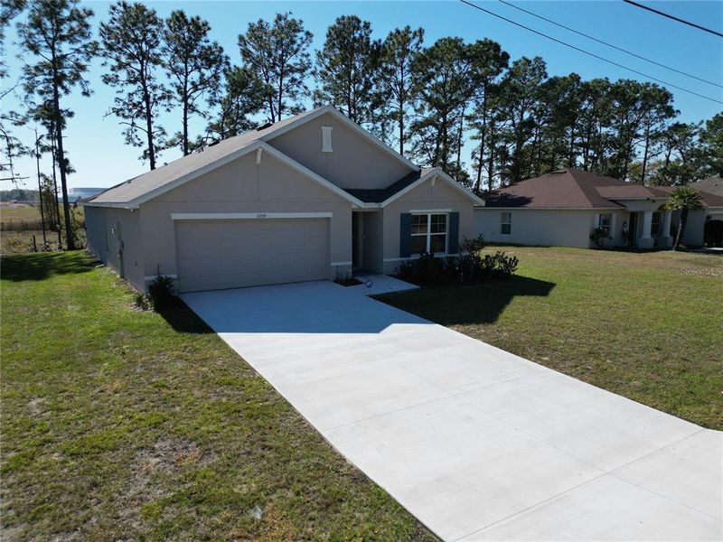 Front exterior of a new home in Marion County Spot Lots, Ocala, FL, highlighting curb appeal (Image 18).